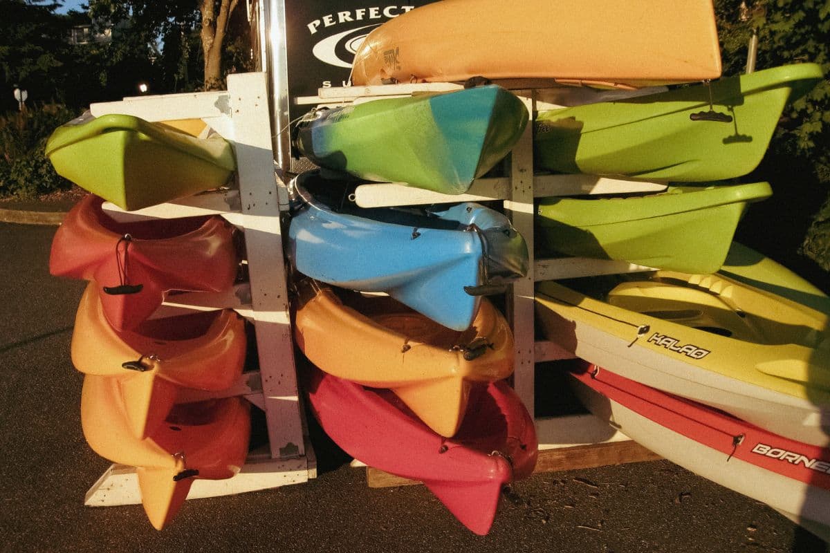 Multiple kayaks for sale displayed on a rack