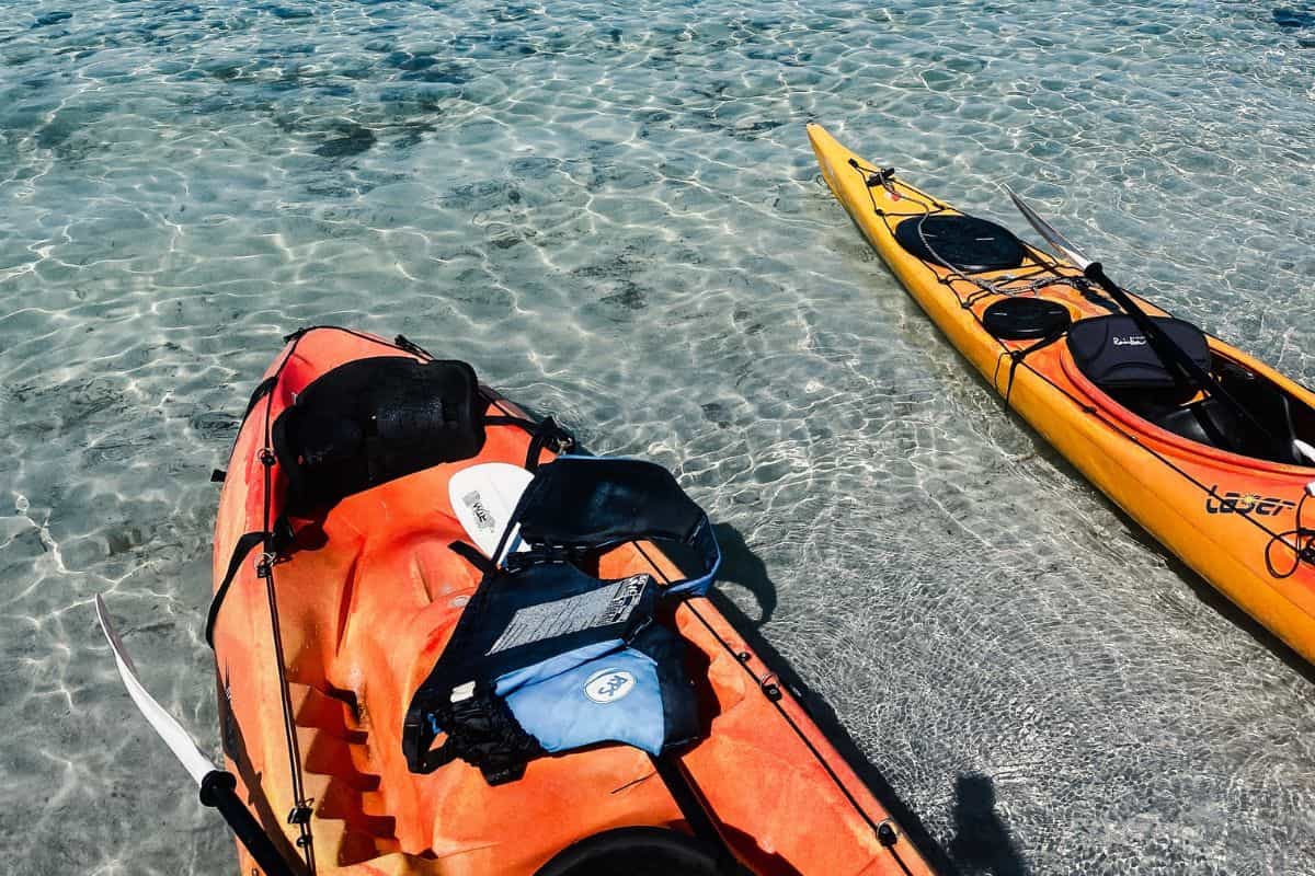Two kayaks in shallow water near the shore