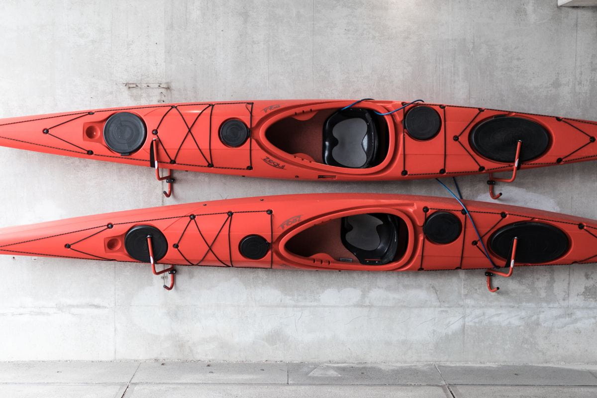 Two red kayaks mounted on the wall
