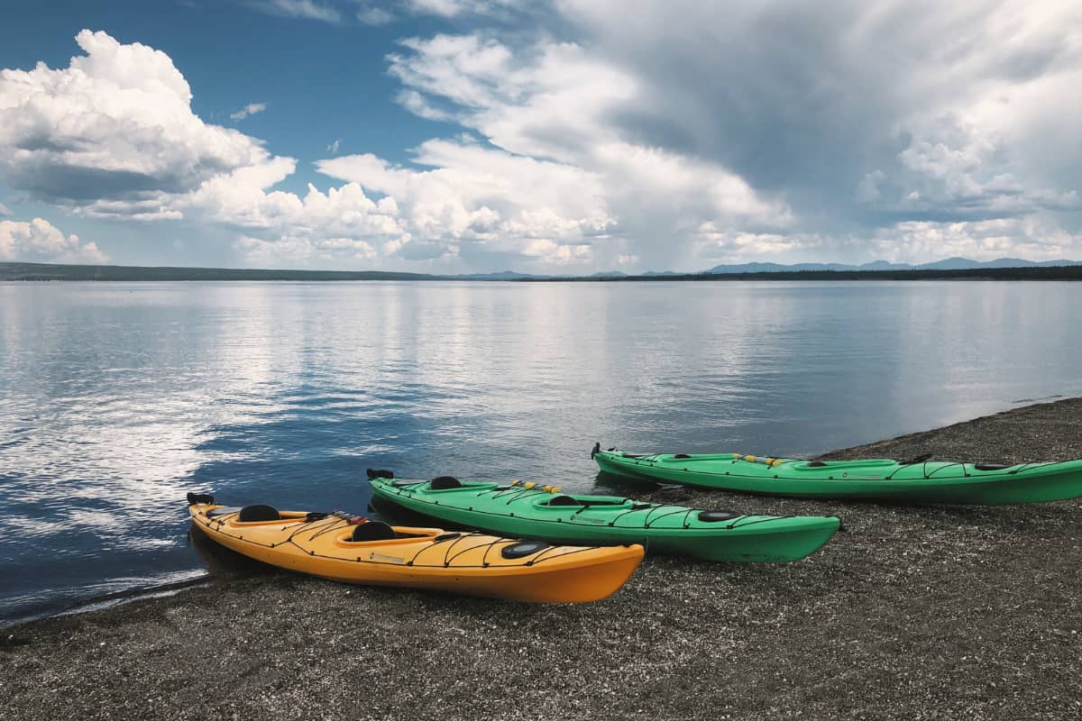 Three kayaks unattended along the shore