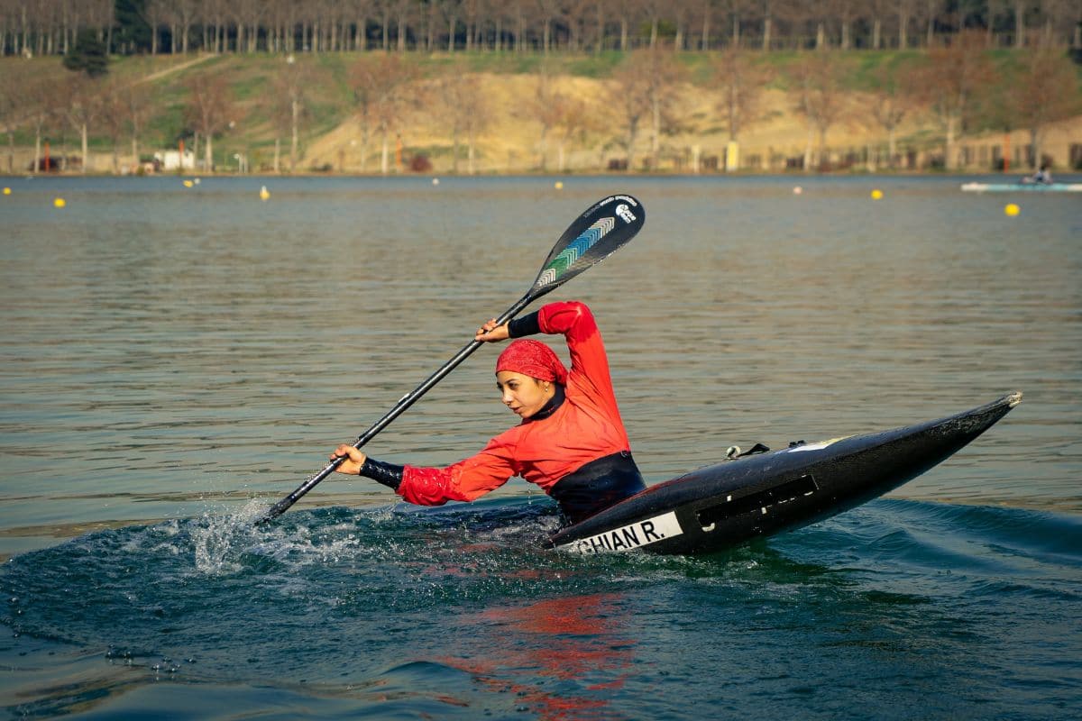 Woman trying to stabilize a sinking kayak