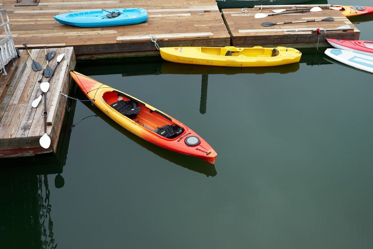 Tandem kayak and single person kayaks by the docks