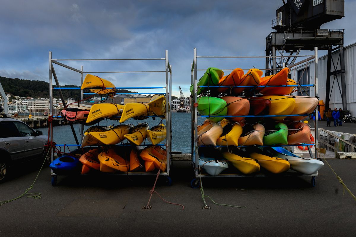 Multiple used kayaks displayed on a rack