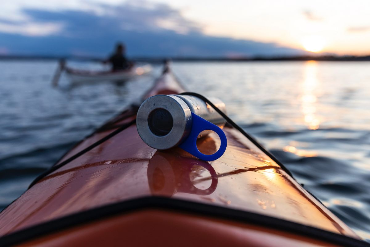 Water bottle strapped to the bow of a kayak